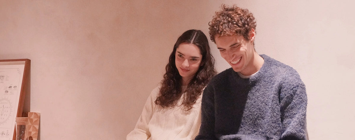 Two models, one male and one female, laughing and smiling