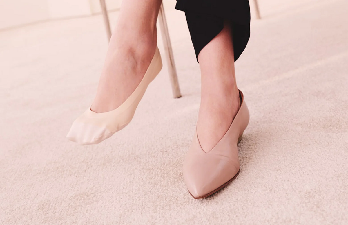 The Low-Cut No Show Socks in Cream Beige on foot paired with ballet flats