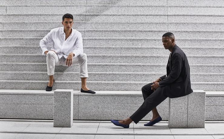 Two men sitting on white marble steps wearing ONDO's Organic Cotton No Show Socks